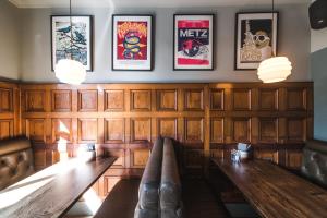 a dining room with a table and some pictures on the wall at The Waterman in Cambridge