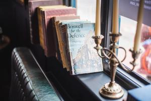 a group of books sitting on a window sill at The Waterman in Cambridge