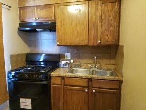 a kitchen with a stove and a sink at Budget Inn in Chickasha