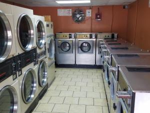 a laundry room with multiple washers and dryers at Budget Inn in Chickasha