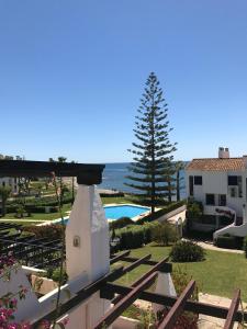 a view of the pool and the ocean from a house at apartment by the beach in Mijas Costa