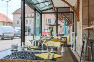 una mesa con sillas y copas de vino en la parte superior de un restaurante en Hotel du Commerce, en Pouilly-en-Auxois