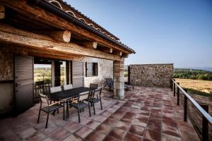 a patio with a table and chairs on a house at La Codina in San Bartolomé del Grau