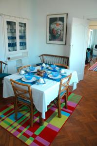 a dining room table with blue dishes on it at Blue On Blue Bed and Breakfast in St. James