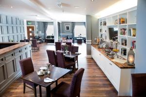 a restaurant with tables and chairs and a bar at The Gateway Hotel in Swinford