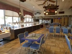 a dining room with a blue table and chairs at Beach Terrace Motor Inn in Wildwood
