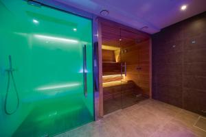 a bathroom with a shower with a glass door at Koru Hôtel & Private Wellness in Autre-Église +154 photos