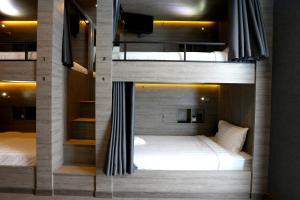 a room with two bunk beds in it at The Printing House Poshtel in Bangkok