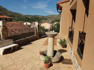 um banho de pássaros de pedra ao lado de um edifício em Apartamentos las Fuentes del Alto Tajo em Peralejos de las Truchas