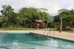 a swimming pool in front of a house at Ritigala Lodge in Habarana