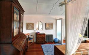 a room with a bed and a dresser and a window at Blue On Blue Bed and Breakfast in St. James