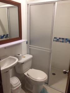 a bathroom with a toilet and a sink and a shower at Brizzamar Hotel in Santa Marta