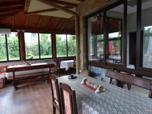 a dining room with a table and a piano at Guest House Ivel in Sapareva Banya +38 photos