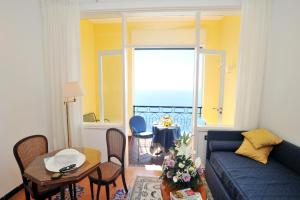 a living room with a blue couch and a table at Hotel Belvedere in Conca dei Marini