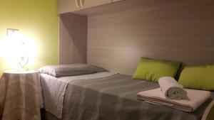 1 Schlafzimmer mit 2 Betten und grünen Kissen in der Unterkunft Il posto ideale in Rom