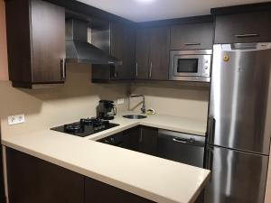a kitchen with a stainless steel refrigerator and microwave at Casa Leo in Cee
