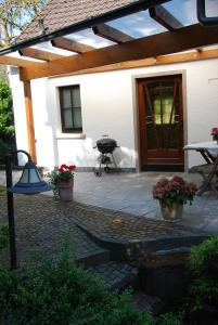 a patio with a bbq grill and a house at Kleine Stuga in Windfuß