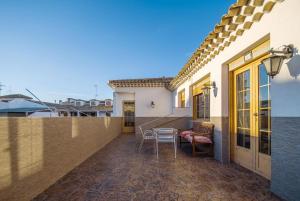 a balcony of a house with a table and chairs at Hostal Nuevo Milán I in San Clemente