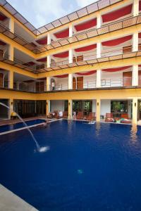 a hotel with a large swimming pool in front of a building at Keeree Ele Resort in Ko Chang