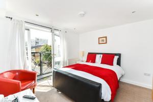 a bedroom with a large bed and a large window at City View House in London