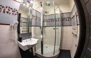 a bathroom with a sink and a shower at Apartamenty Centrum in Koszalin