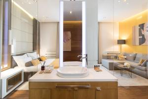 a bathroom with a sink and a living room at Dominic Smart & Luxury Suites - Terazije in Belgrade