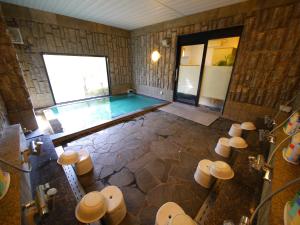 a large bathroom with a swimming pool in it at Hotel Route-Inn Shin-Shirakawa Eki Higashi in Shirakawa