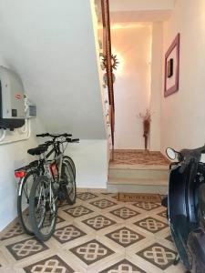 two bikes parked in a room with a tile floor at B&B MaryGrace in Alghero