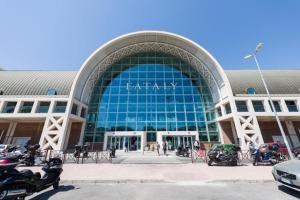a large glass building with motorcycles parked in front of it at Guglielmo Marconi House in Rome