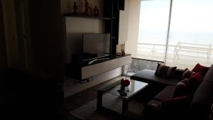 ein Wohnzimmer mit Sofa und Flachbildfernseher in der Unterkunft Lima Flats 3 in Lima