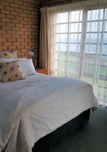 a bedroom with a bed and a window at Stanley Village Waterfront Accommodation in Stanley