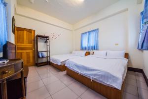 Cama o camas de una habitación en Happy Garden Homestay