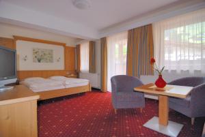 Łóżko lub łóżka w pokoju w obiekcie Hotel Garni Forelle
