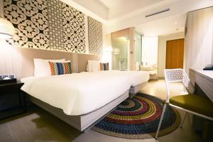 
a hotel room with a large bed and a large mirror at Hue Hotels and Resorts Puerto Princesa Managed by HII in Puerto Princesa City
