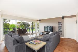 a living room with two couches and a tv at 'Hope House' - Encounter Bay in Kilki