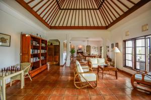 een woonkamer met een bank, stoelen en een tafel bij Bukit Asri Lodge in Seraya