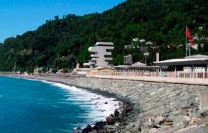a beach next to the ocean with a mountain at Guesthouse Maria in Sarpi