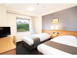 Postel nebo postele na pokoji v ubytování Smile Hotel Wakayama