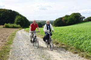 two people riding bikes down a dirt road at De Hagendoorn in Moorveld +3 photos