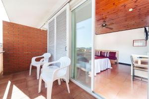 a living room with white chairs and a table at Hotel Xaine Park in Lloret de Mar