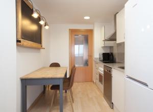 A kitchen or kitchenette at Apartment Beach Front Canet