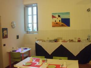a room with two tables and a table with at B&B CARAVAGGIO SIRACUSA -200 Metres from Ortigia- in Siracusa