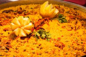 a pot of food with a flower on top of it at Hotel Xaine Park in Lloret de Mar