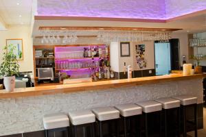 a bar with white stools and a purple ceiling at Winzerhaus Gärtner - An der Loreley in Sankt Goar +26 photos