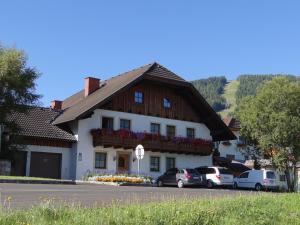 a building with cars parked in a parking lot at Haus Edelweiss in Sankt Margarethen im Lungau