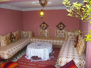 a living room with a couch and a table at Riad Idrissi in Meknès