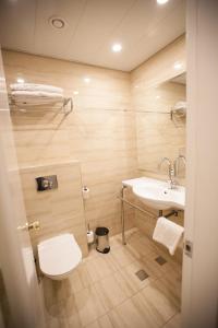 a bathroom with a toilet and a sink at City Center Jerusalem in Jerusalem +28 photos