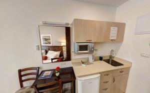 a small kitchen with a table and a microwave at City Center Jerusalem in Jerusalem