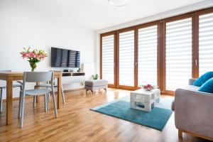 a living room with a table and a dining room at JT Apartments/Dworska in Krakow