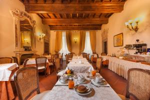 a restaurant with tables and chairs with food on them at Hotel San Michele in Cortona